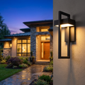 Modern luxury outdoor wall lamp mounted on house exterior, glowing at dusk