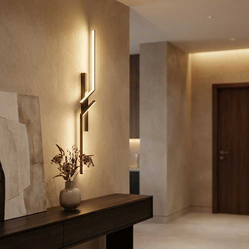 Luxury minimalist LED wall sconce mounted in an elegant home entryway, glowing warmly