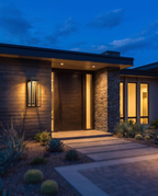 The Grandview Luxe outdoor wall sconce mounted on house exterior at dusk, wide entryway shot