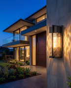 The Cascade Estate Wall Lantern mounted on house exterior at dusk, wide entryway shot