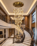 The Sovereign crystal chandelier glowing above a grand villa staircase