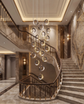 The Aurelia Grand Staircase Chandelier glowing above a villa staircase